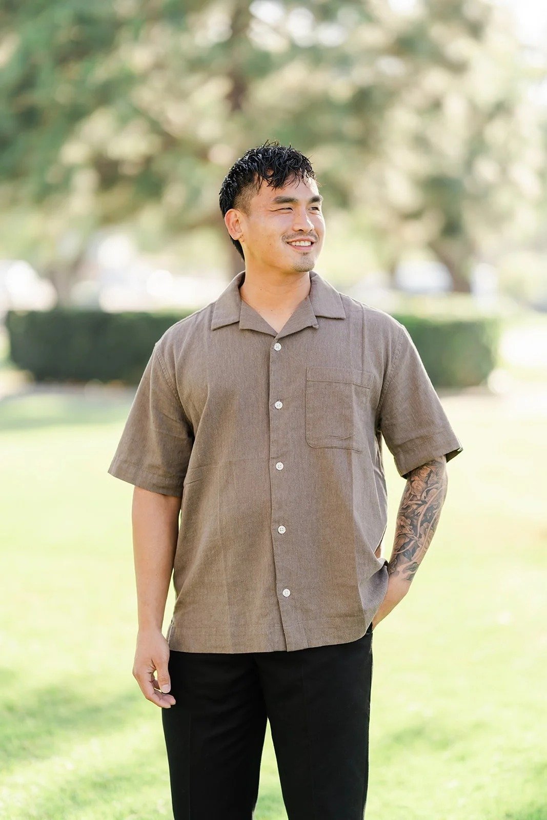 Andrew in an olive button-up shirt on the lawn, photographed by One and Only Production.