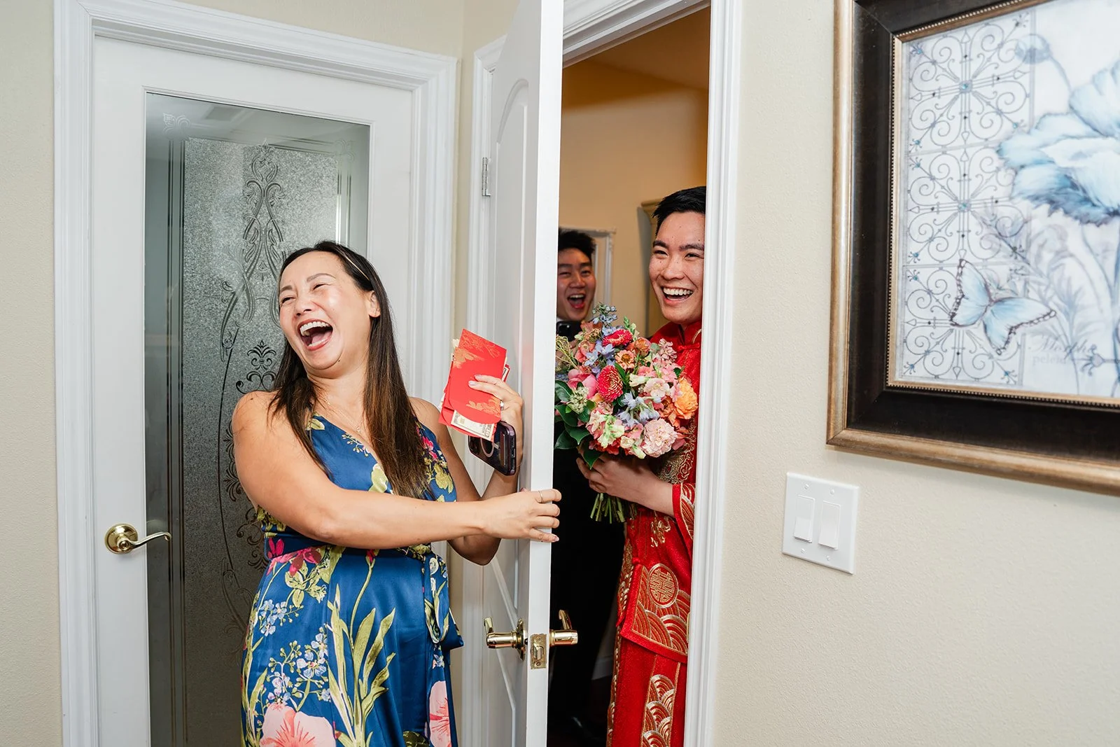 A bridesmaid laughing behind the door.