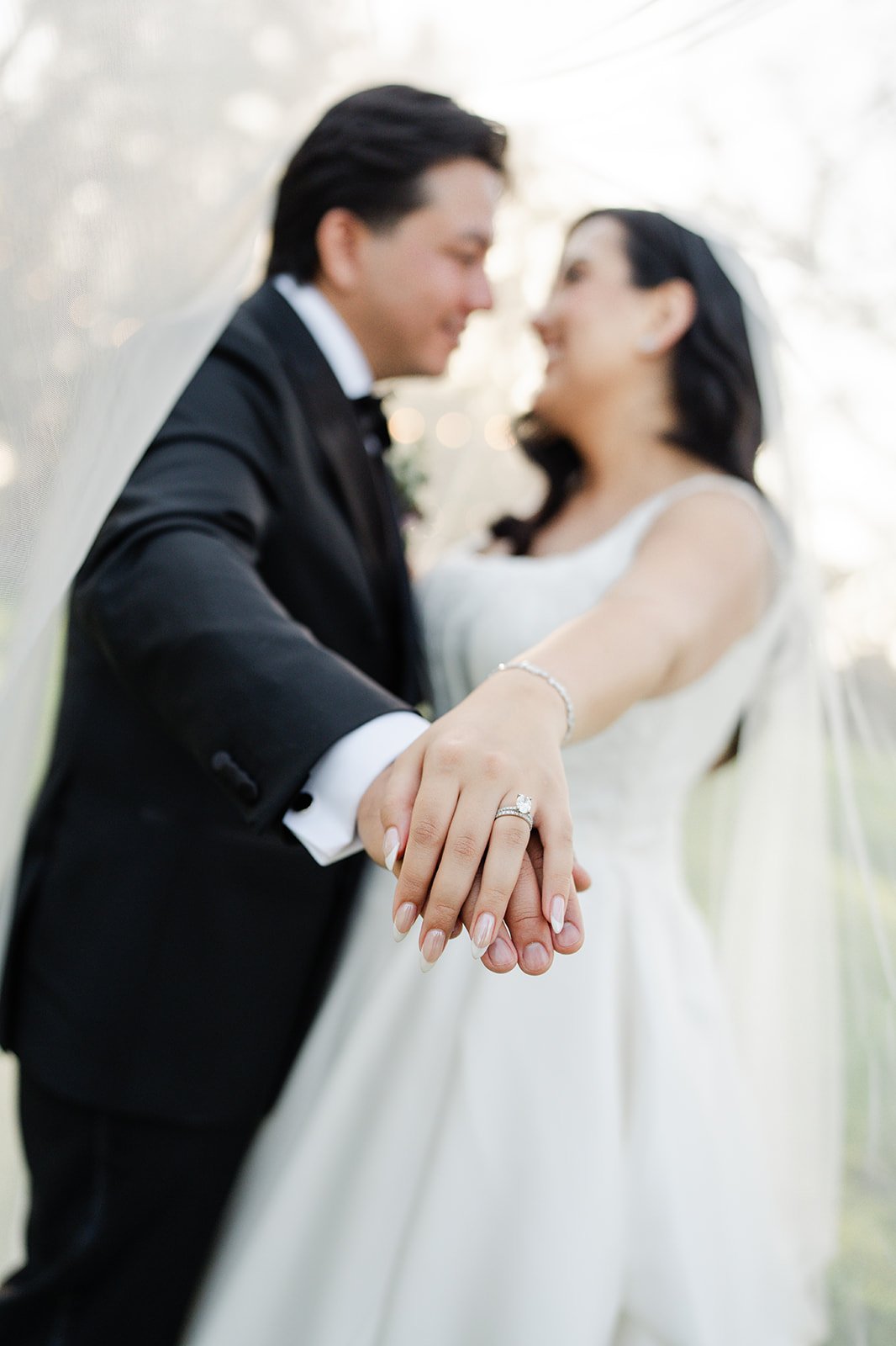 Newlyweds showing their rings and smiling