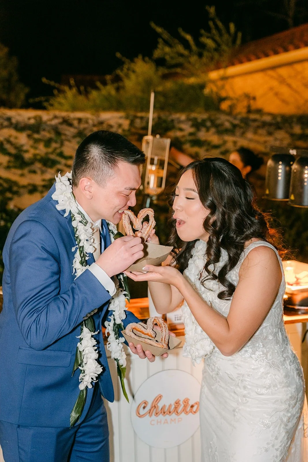 Kelli and Alex feeding each other churros