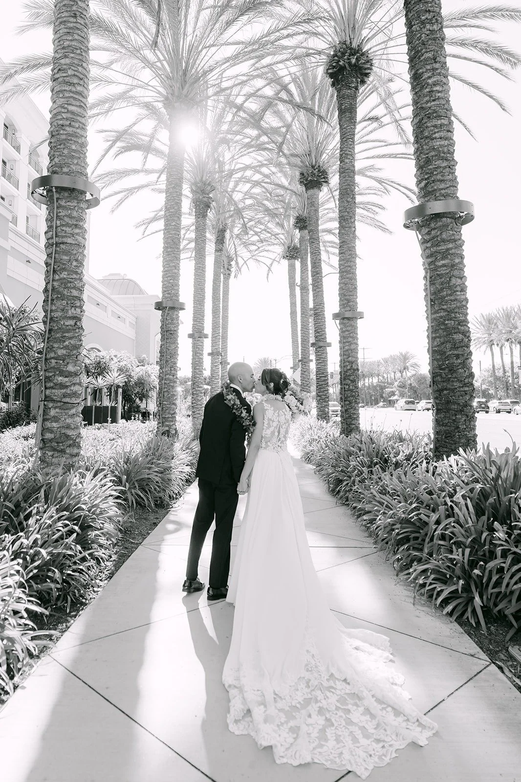Francesca and Daniel on the palm lined walkway at The Westin Anaheim Resort, photographed by One and Only Production