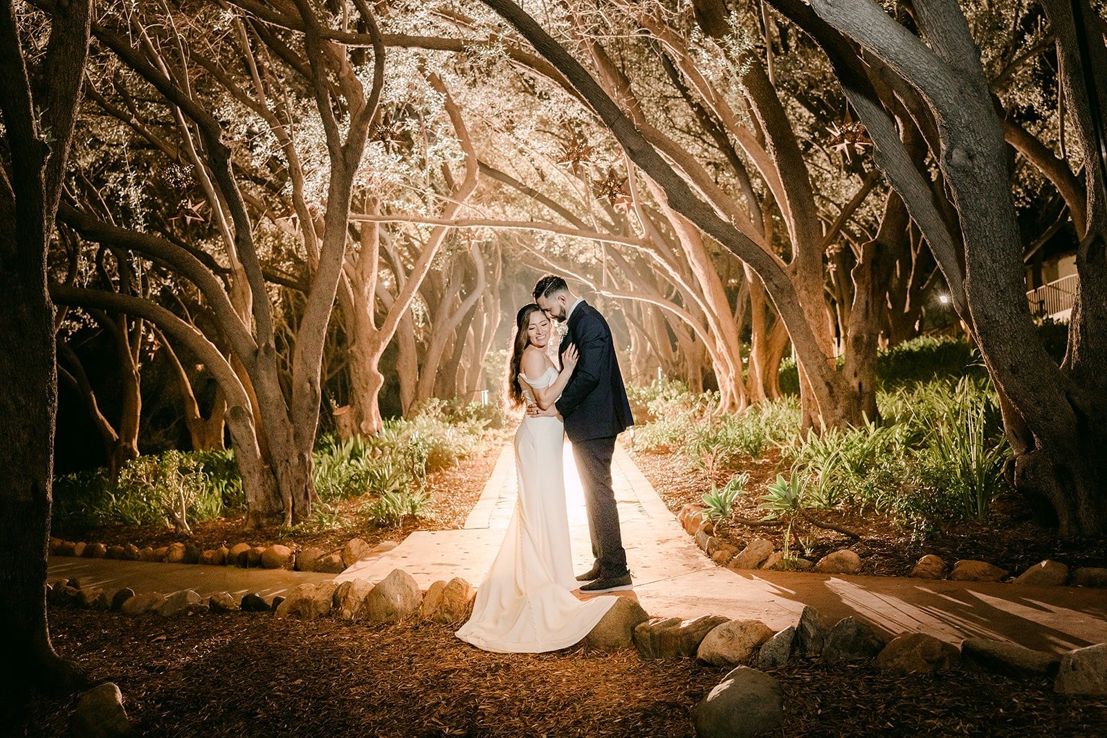Mariana and Danny kissing under the lit branches at Padua Hills Theatre
