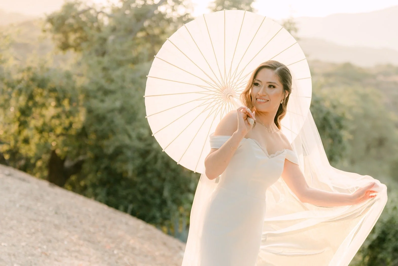 Mariana twirling a white parasol on the hillside at Padua Hills Theatre