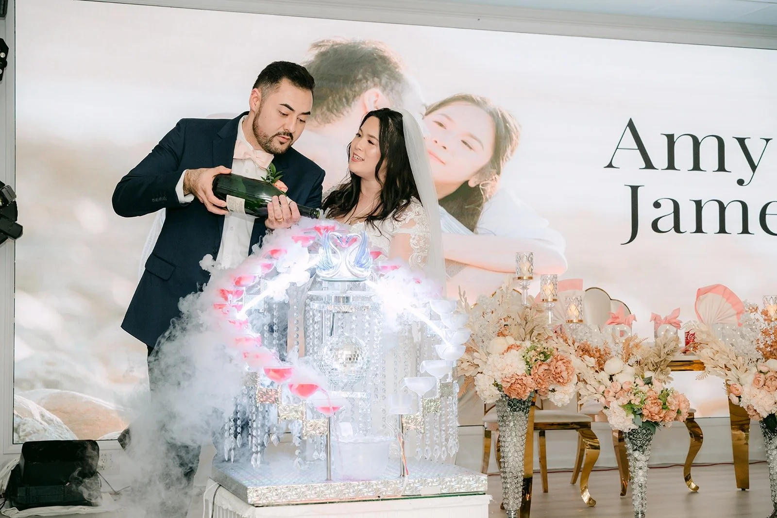 Amy and James toasting at the fog filled champagne display