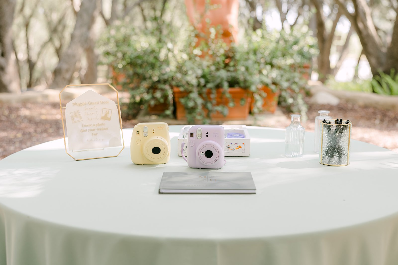 Welcome table with instant cameras for the Polaroid guest book
