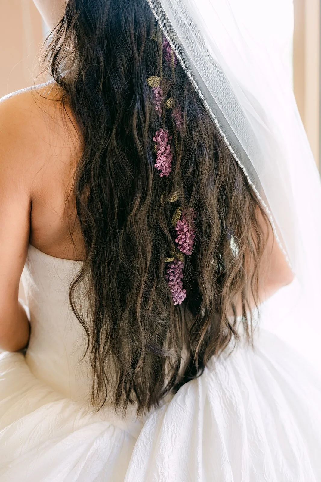 Lavender flowers woven into Angela's hair