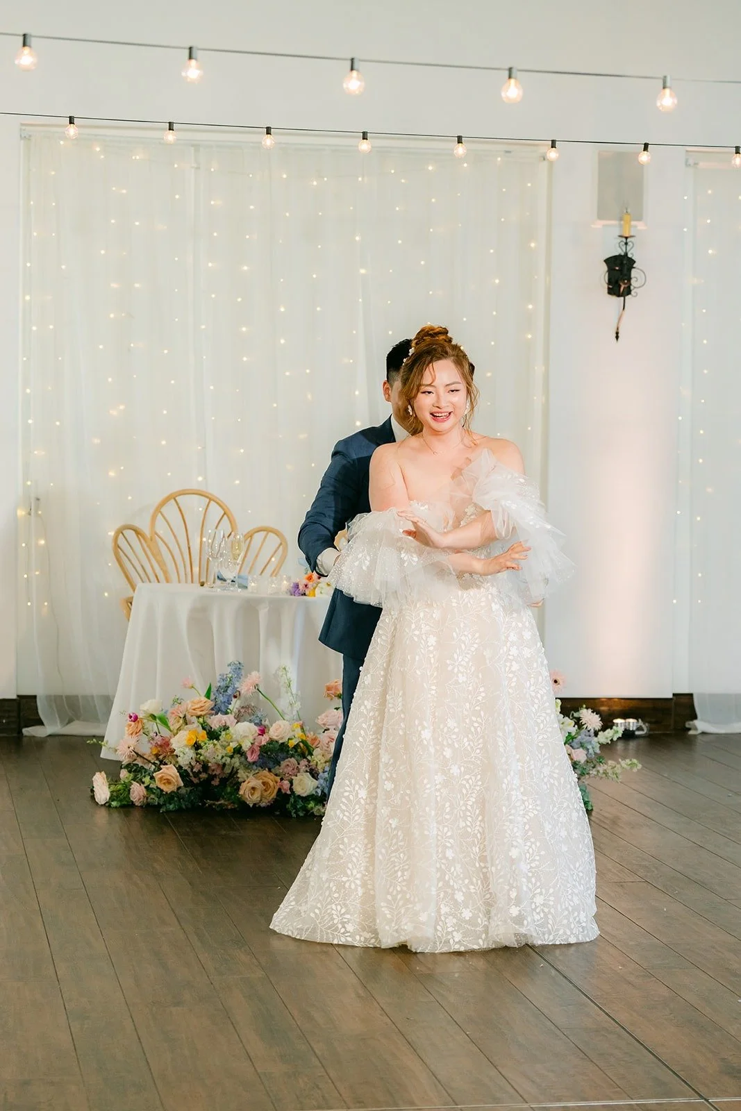 Jerrick dipping Joanna in front of the sweetheart table