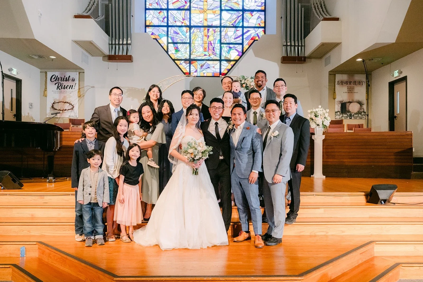 A large family group photo at the altar of Mandarin Baptist Church of Los Angeles