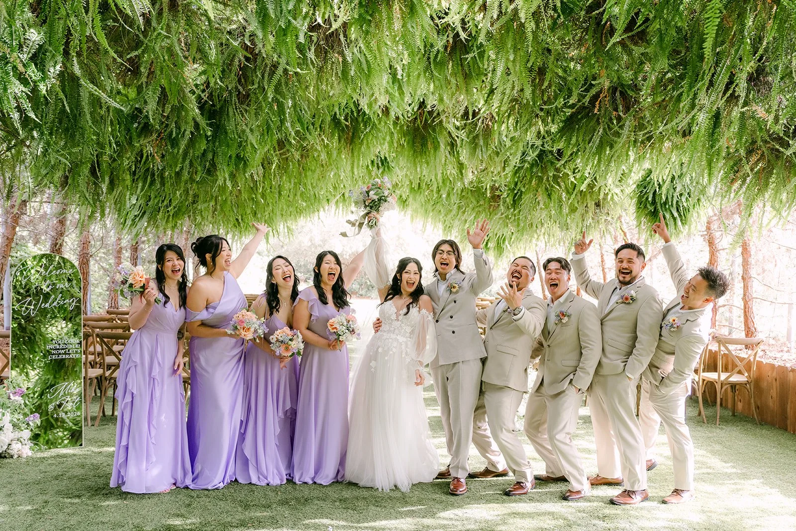 Wedding party celebrating beneath the hanging ferns of the Woodland Grotto