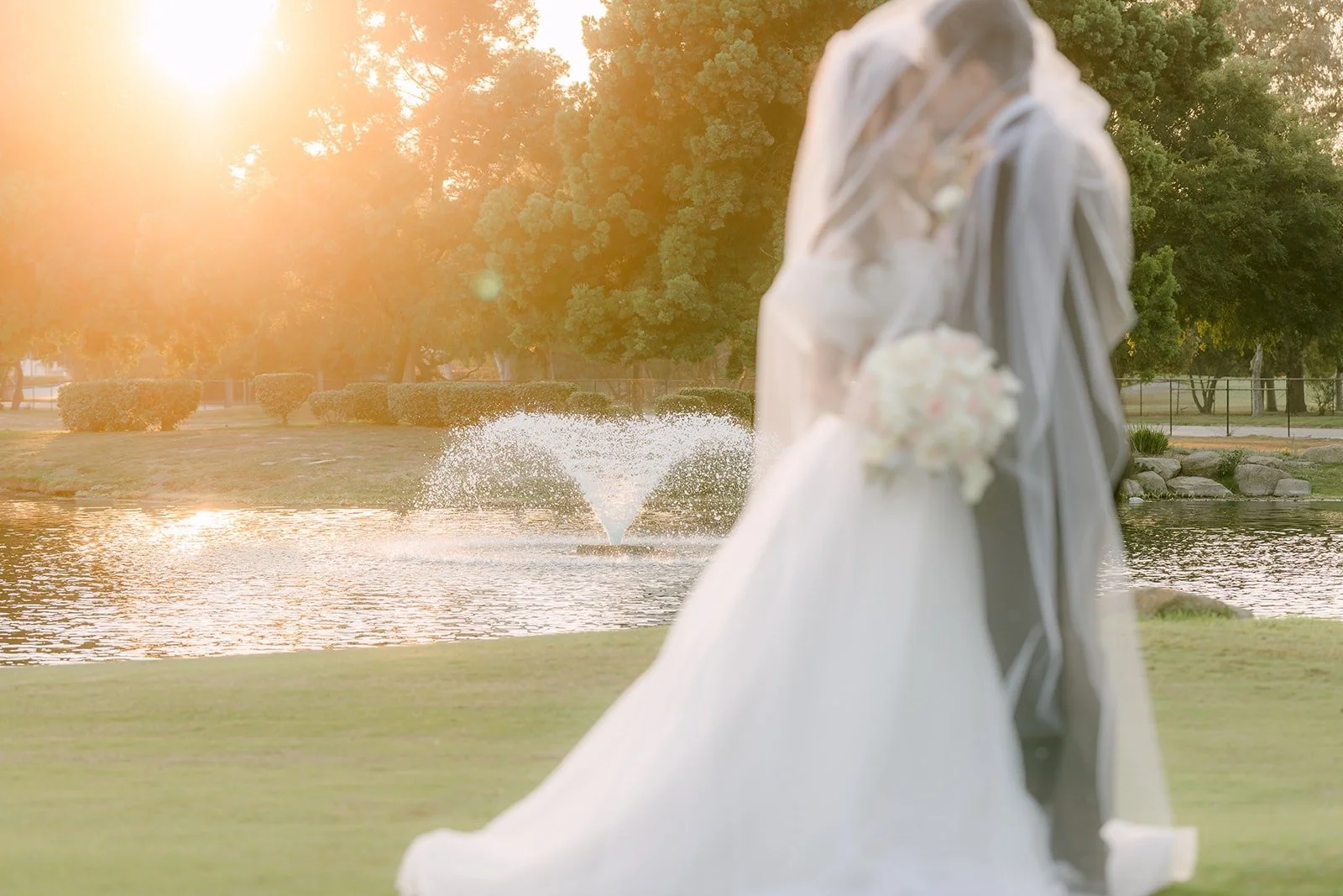Jeannie and Eunsang silhouetted by the setting sun over the lake