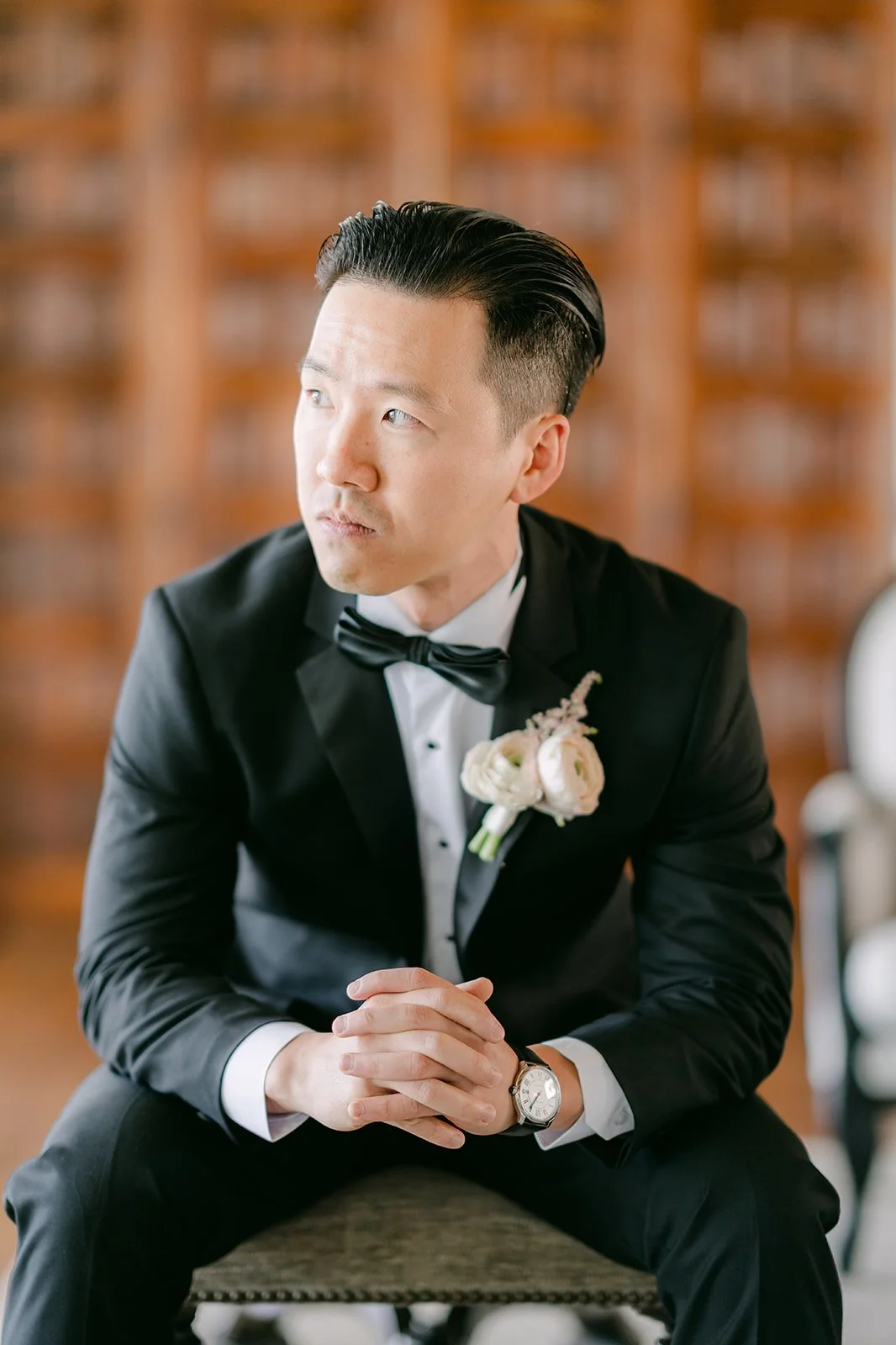 Portrait of the groom in his tuxedo with a blush boutonniere