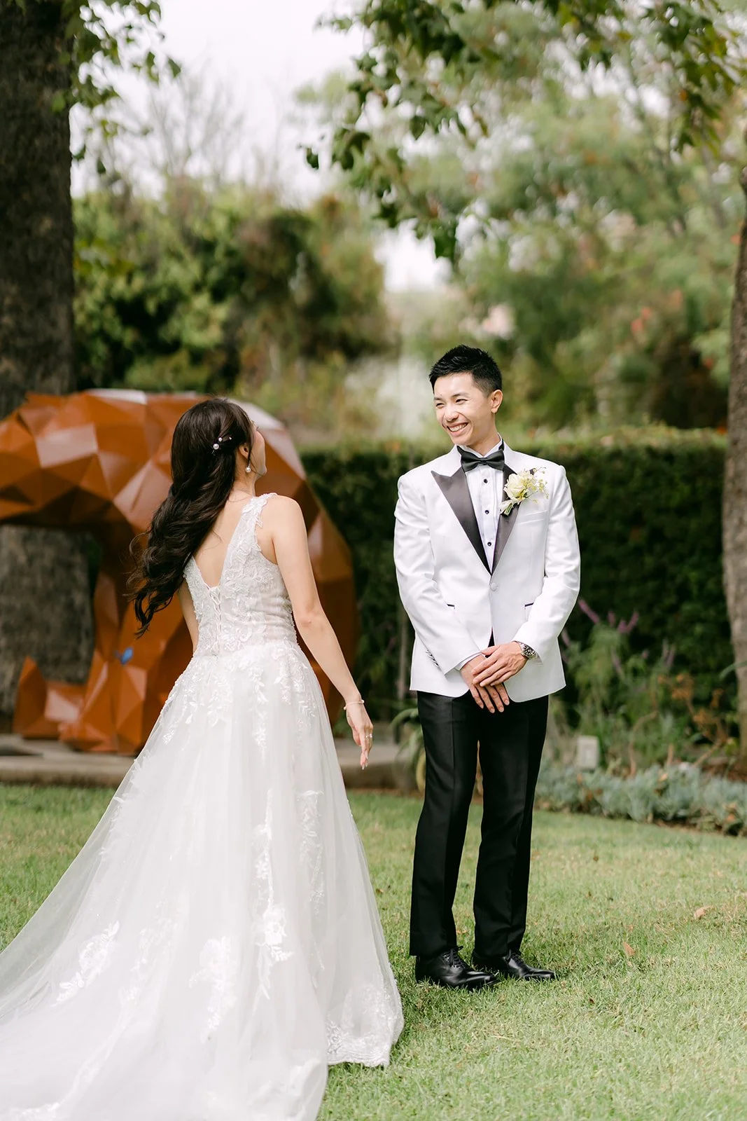 Jenny walking up to Ryan for their first look in the gardens at the Nixon Library.