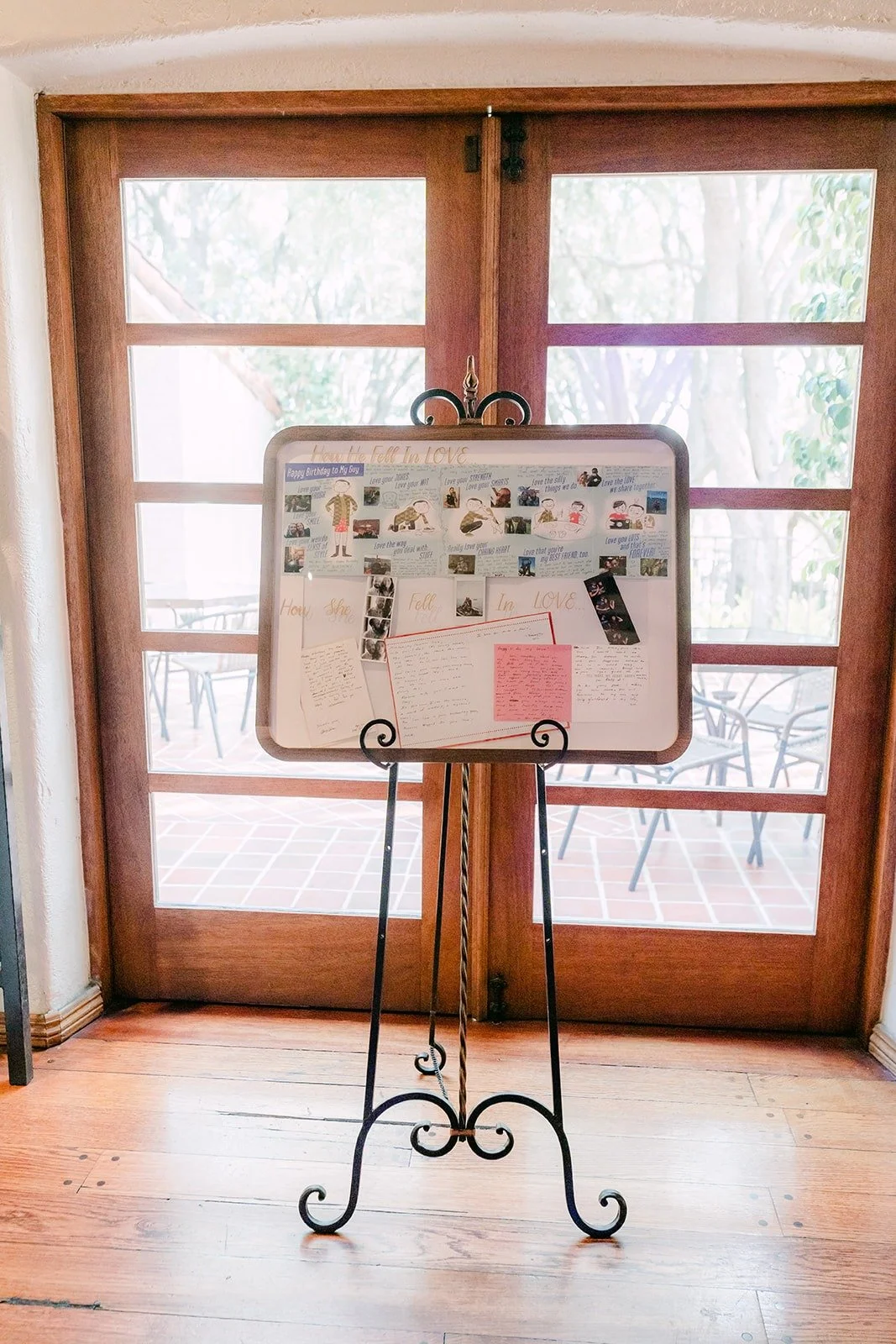 A seating chart on an iron easel by the ballroom doors