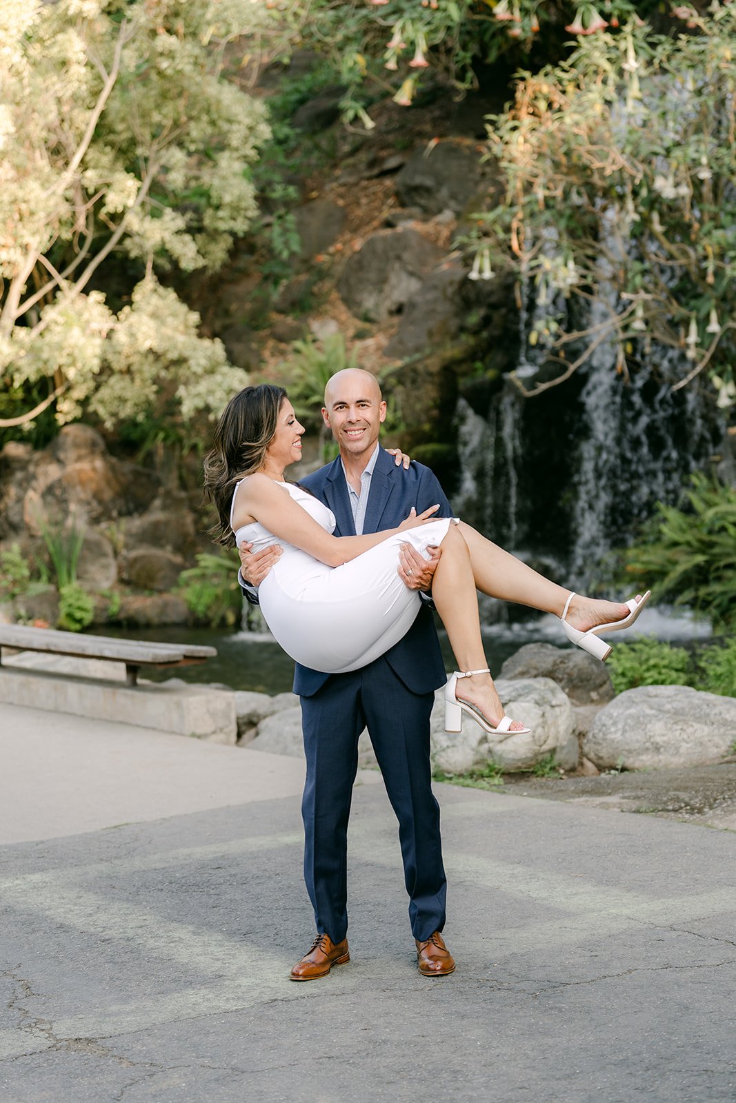 Daniel carries Francesca in his arms near the waterfall.