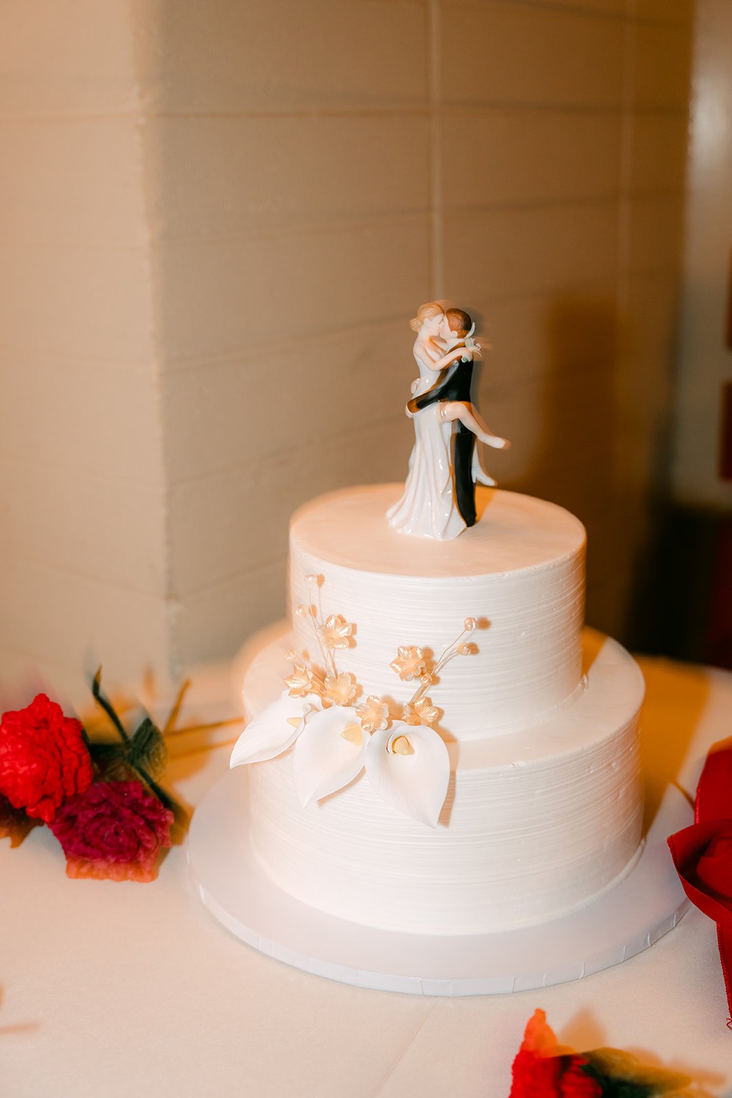 Close-up of the cake topper and white florals.