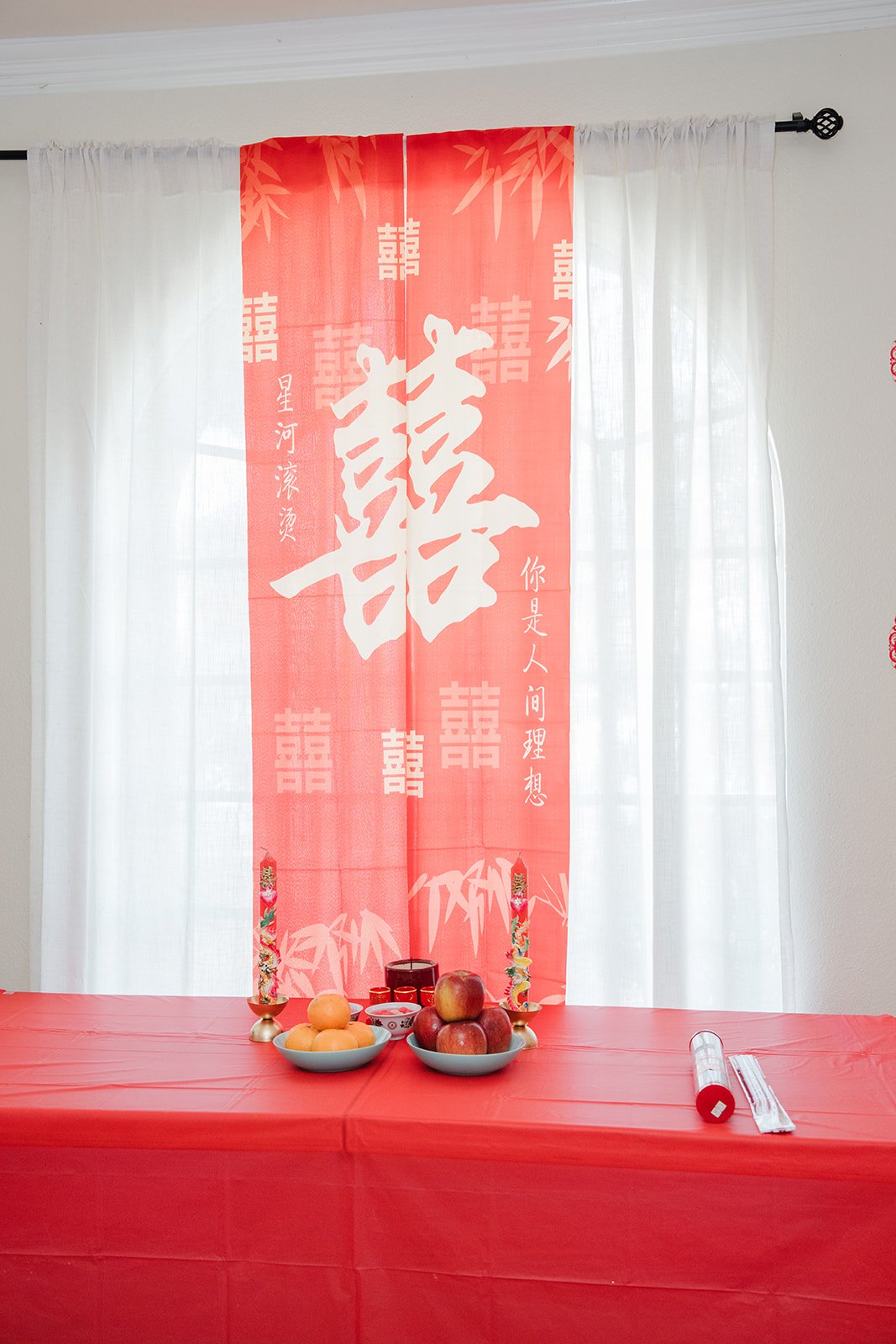 A red double happiness banner over the tea table.
