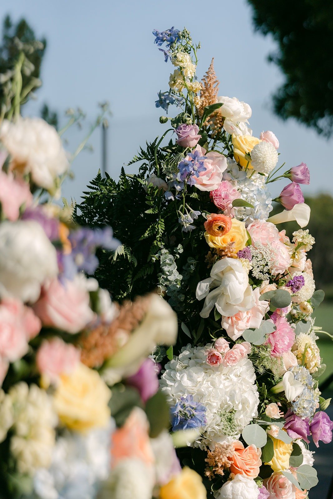 Peach, lavender and ivory blooms on the ceremony florals