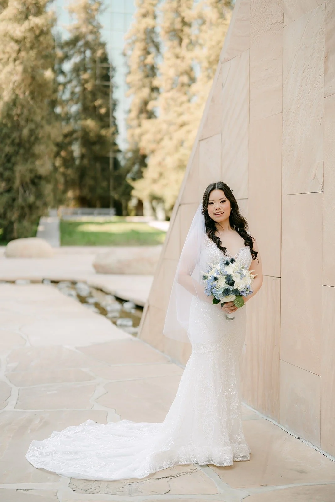 Emily in her lace gown against the stone walls of the Noguchi Garden in Costa Mesa