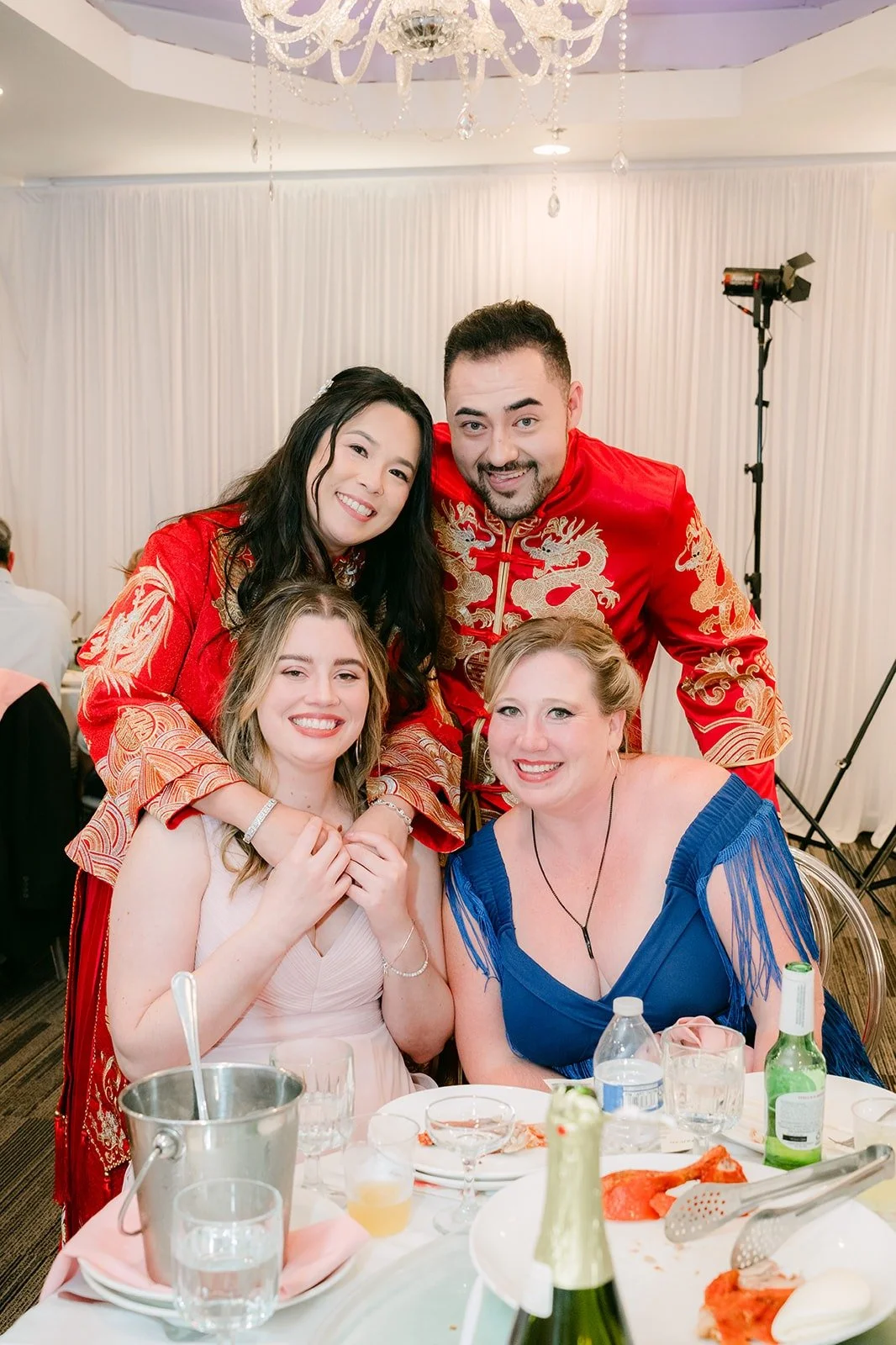 Amy and James with friends at their table, photographed by One and Only Production
