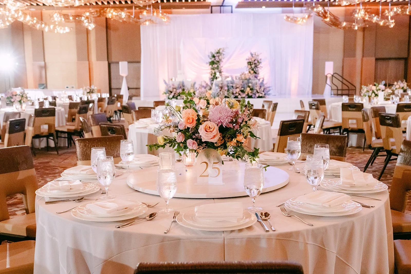 Reception table with a pastel floral centerpiece in the Arbor Ballroom