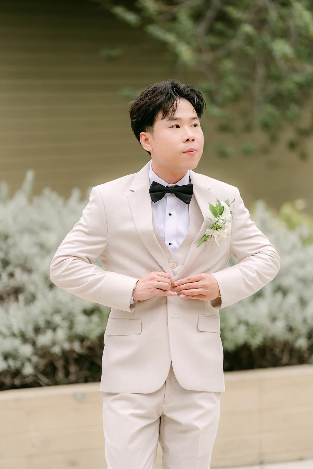 Wen in his cream tuxedo and black bow tie.
