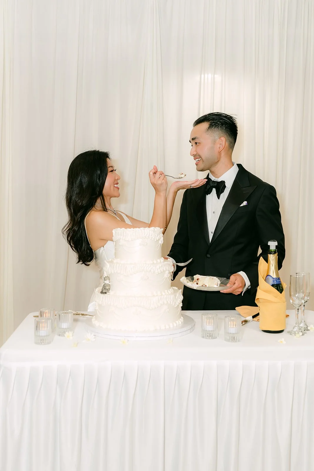 Kim and Vincent sharing a bite of cake
