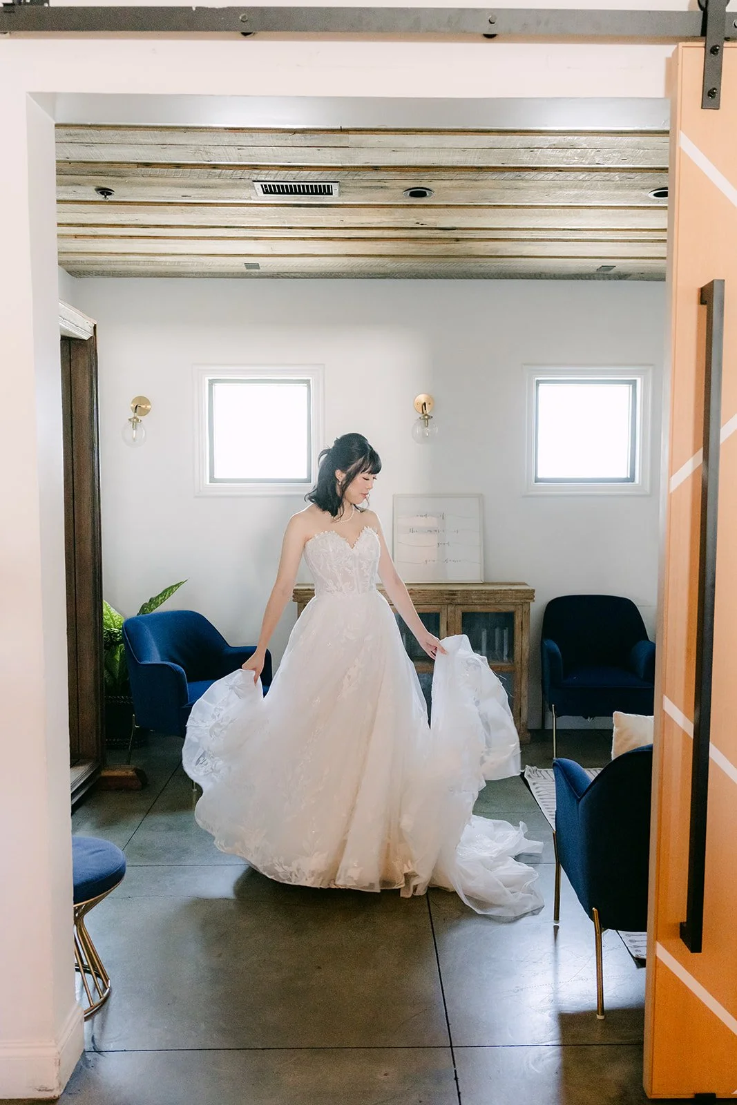Vivian in her gown framed by the bridal suite doorway