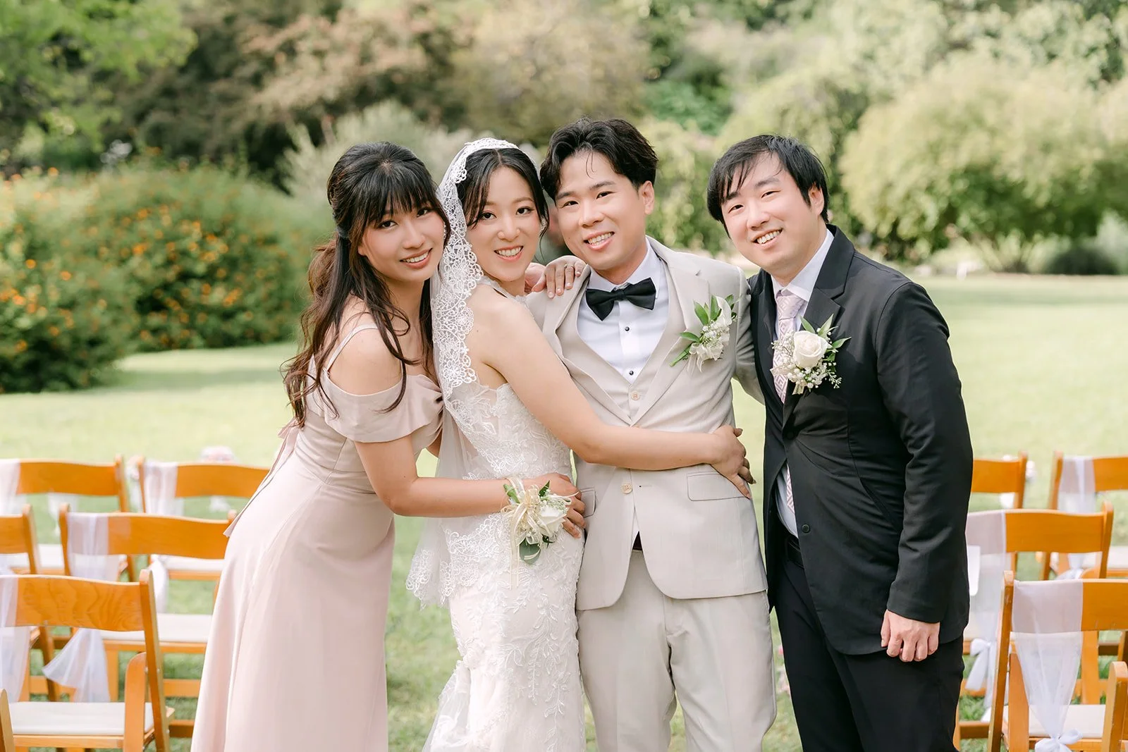 The wedding party laughing in a group hug.