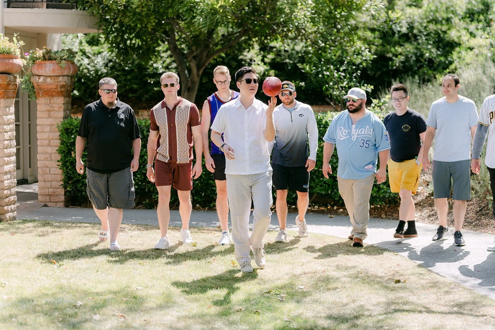 The groomsmen walking in side by side for their game day entrance photo