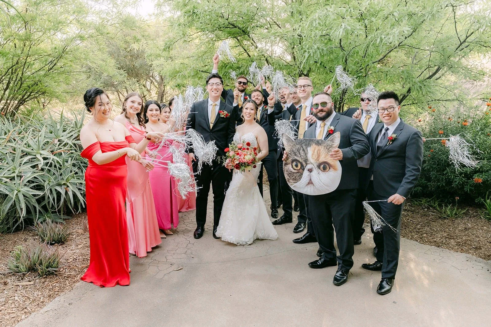 The wedding party gathered with Joanne and Zach on the garden path, photographed by One and Only Production