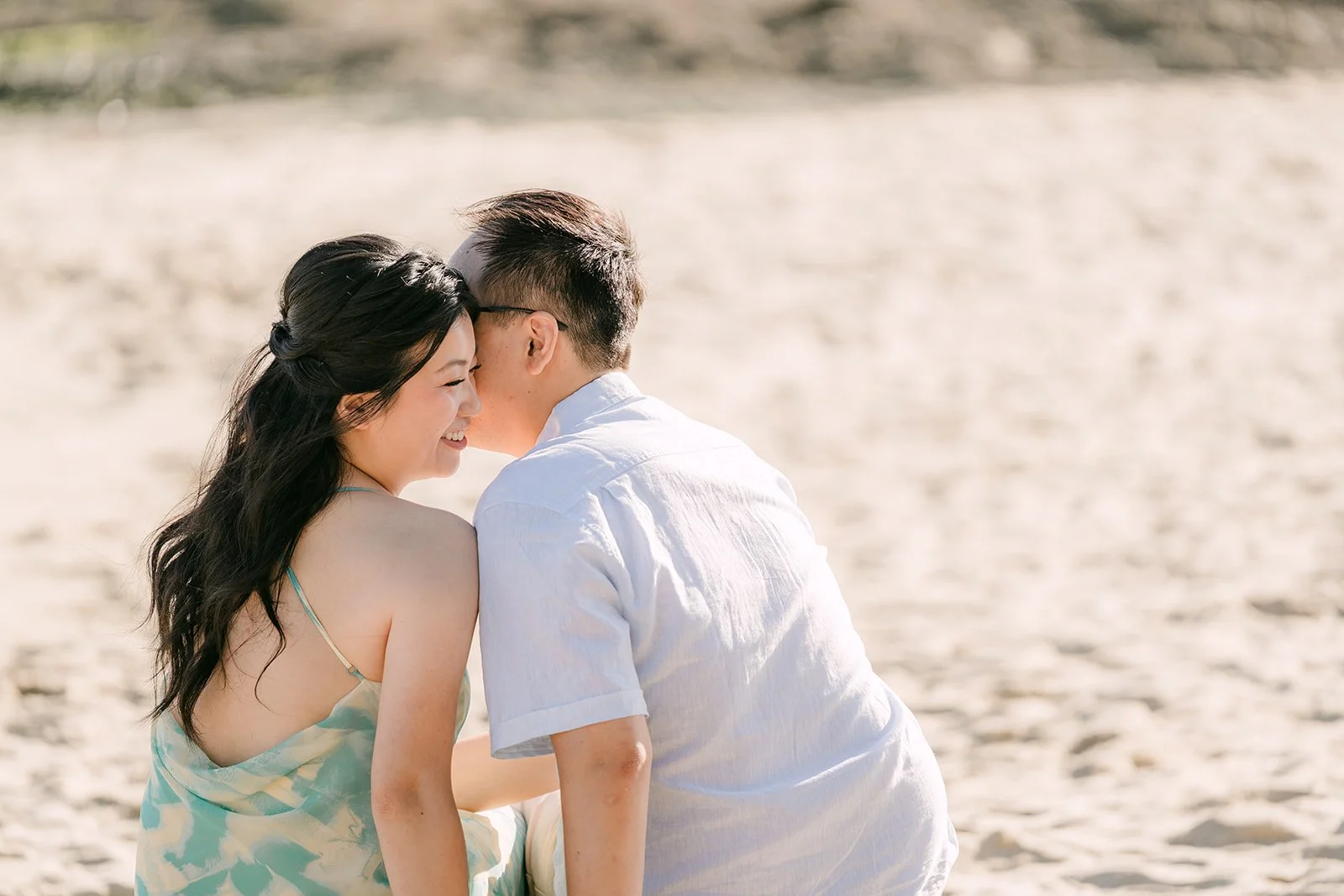 Lawrence kissing Constance's temple on the beach, photographed by One and Only Production.