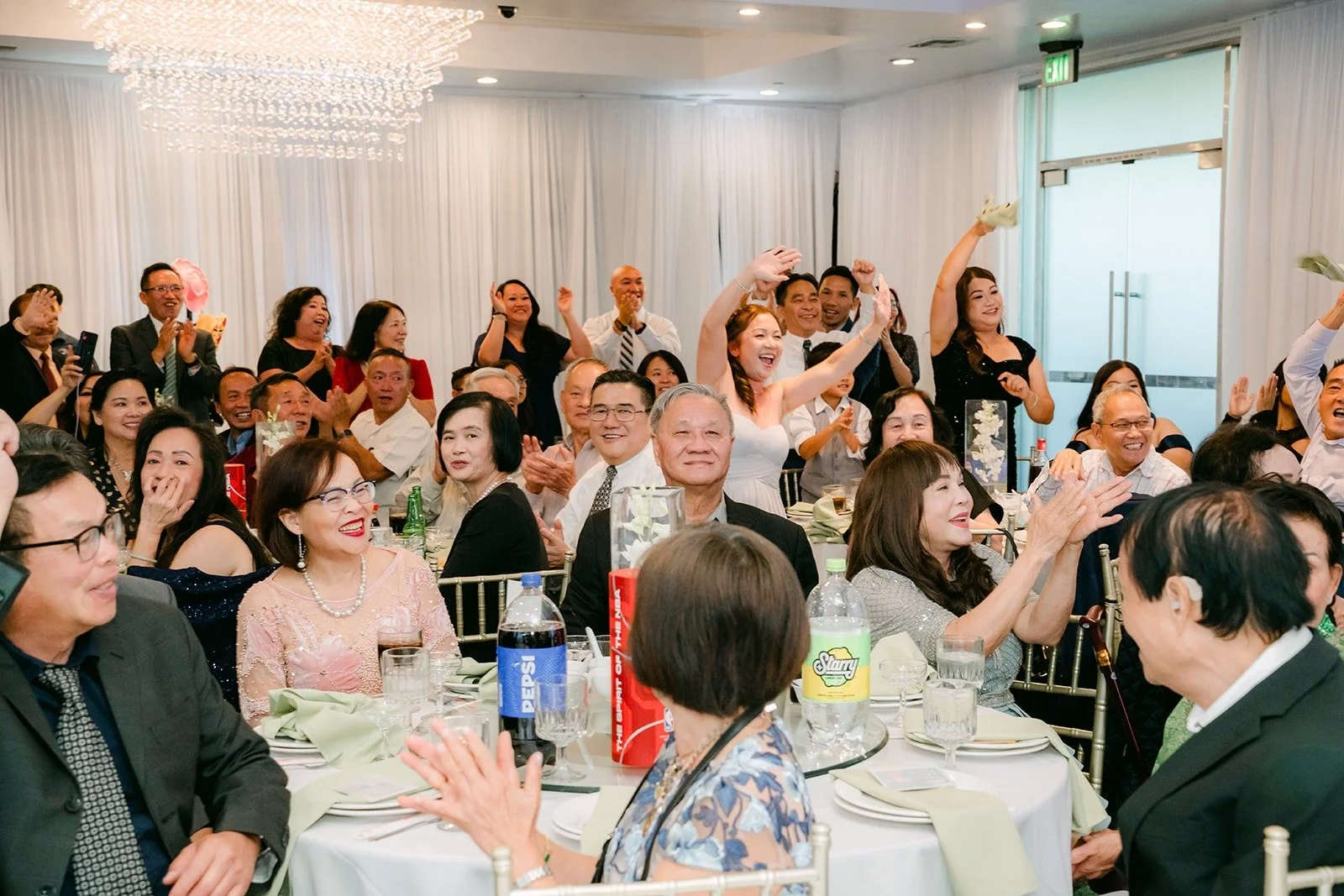 Guests cheer from their tables during the grand entrance