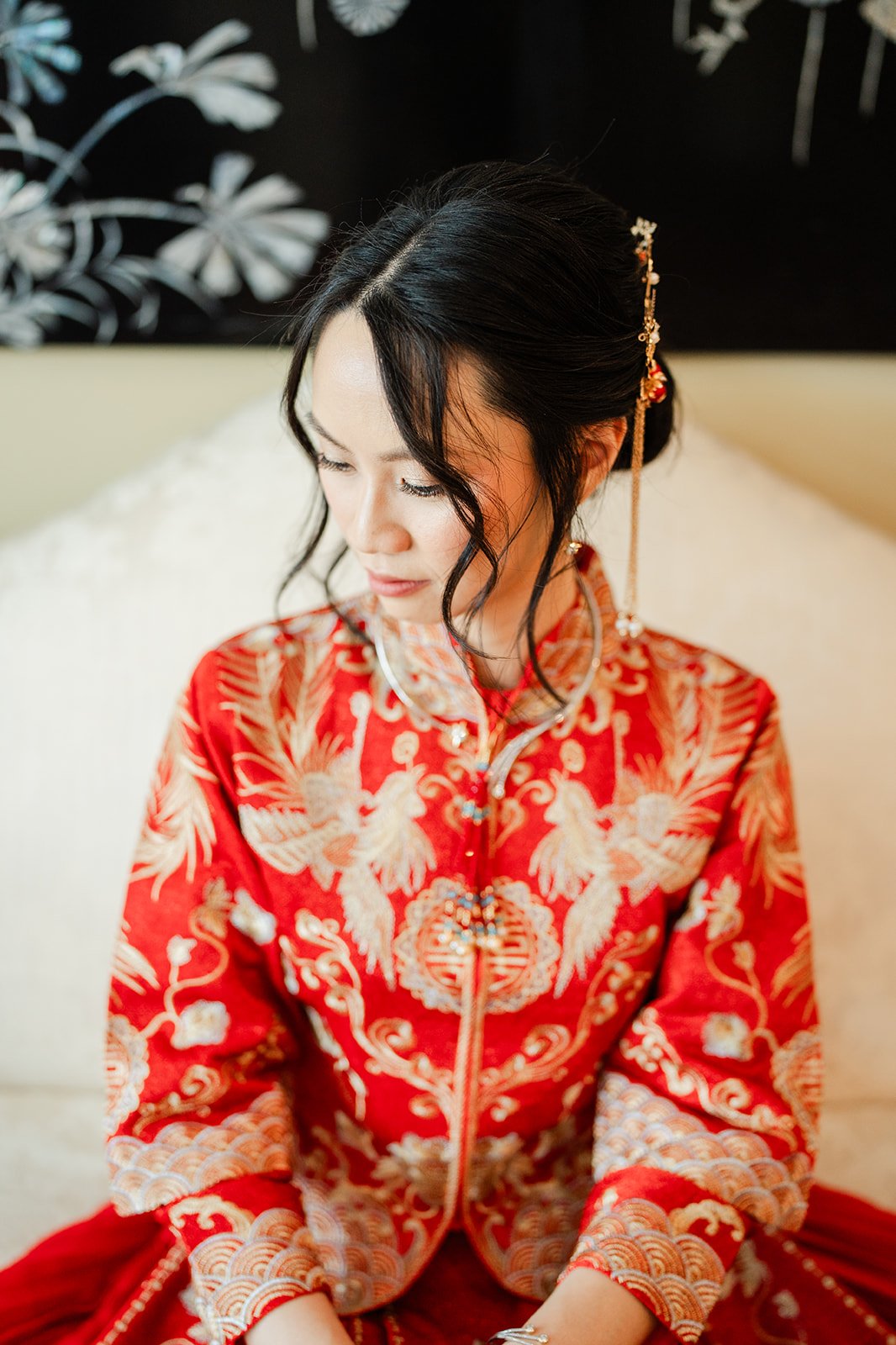A bride in her qun kwa seen from above with gold hair pins.