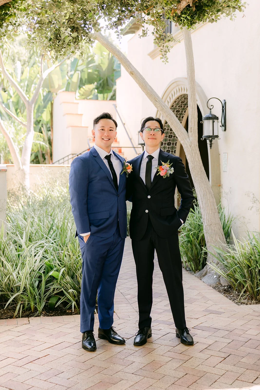 Leroy with a groomsman under the garden archway