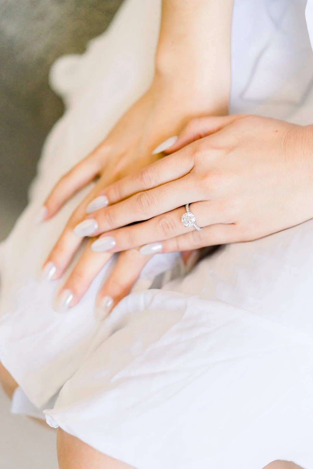 Close up of Josephine's hands and engagement ring