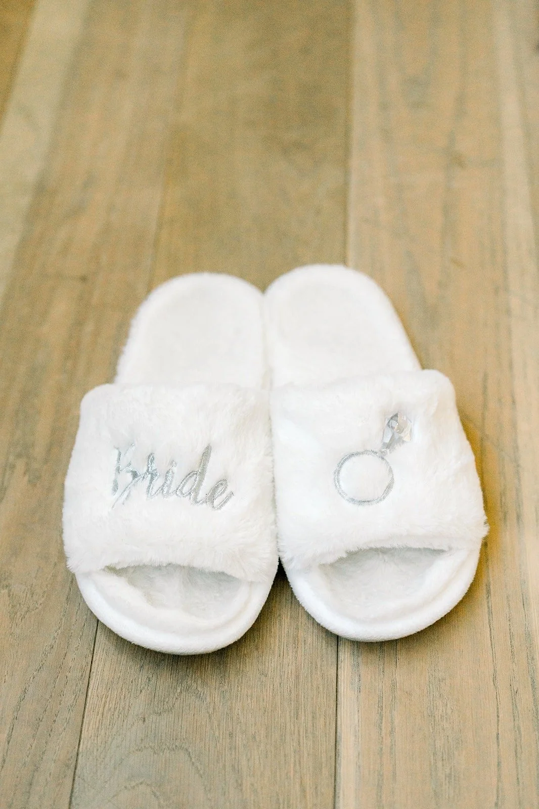 White bride slippers on the wood floor