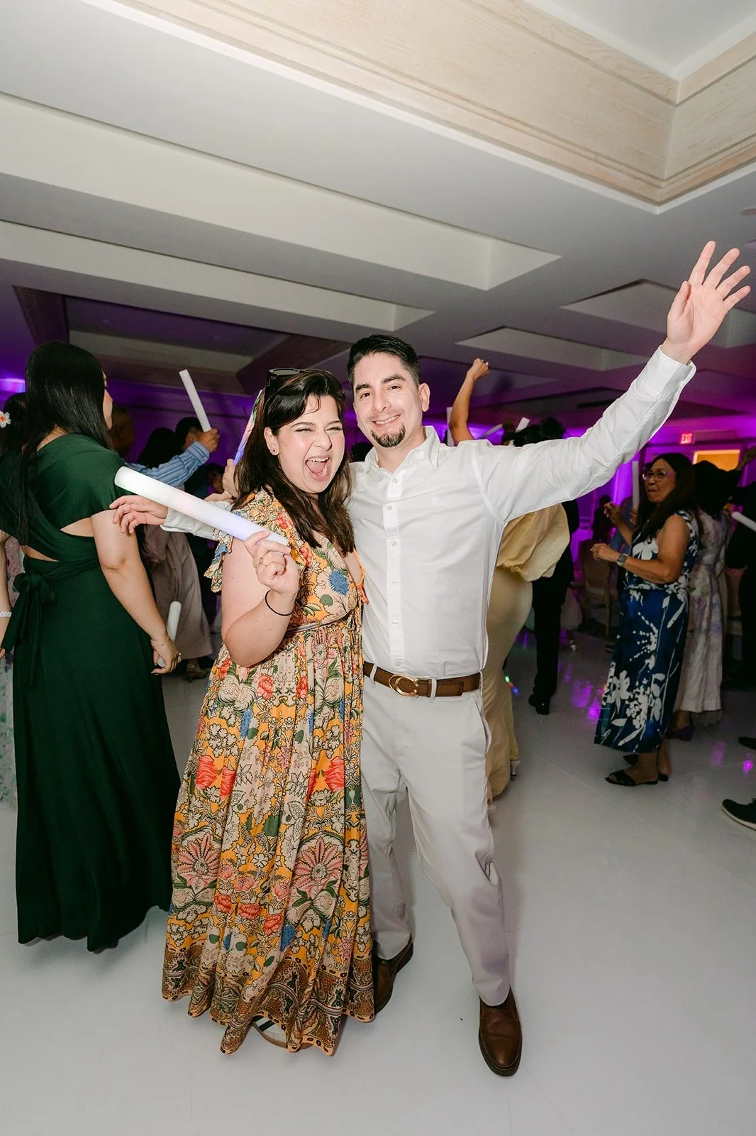 Guests dancing with arms in the air