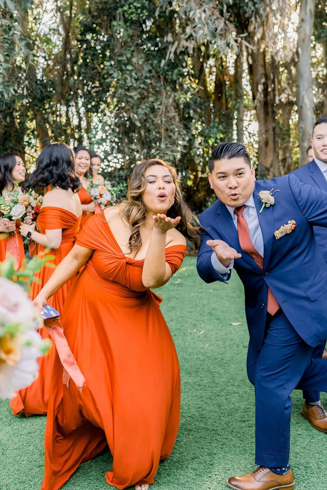A bridesmaid and groomsman striking a playful pose