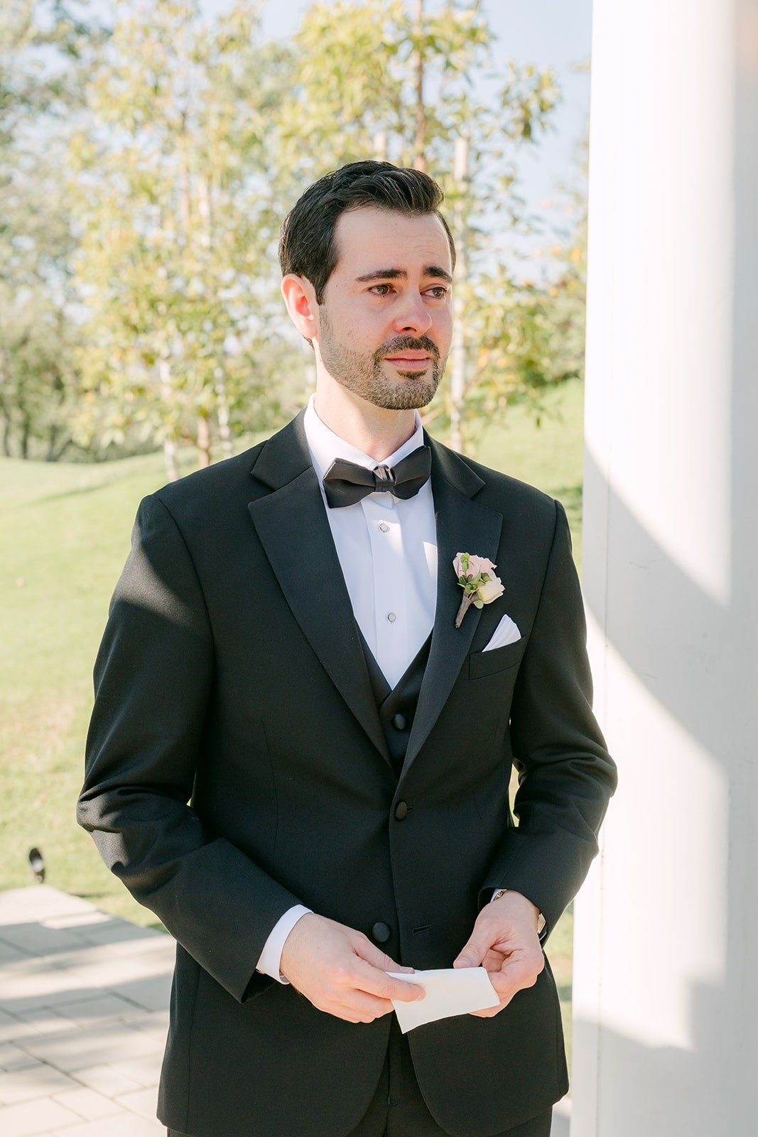 Kevin reading his vows from a card under the pagoda