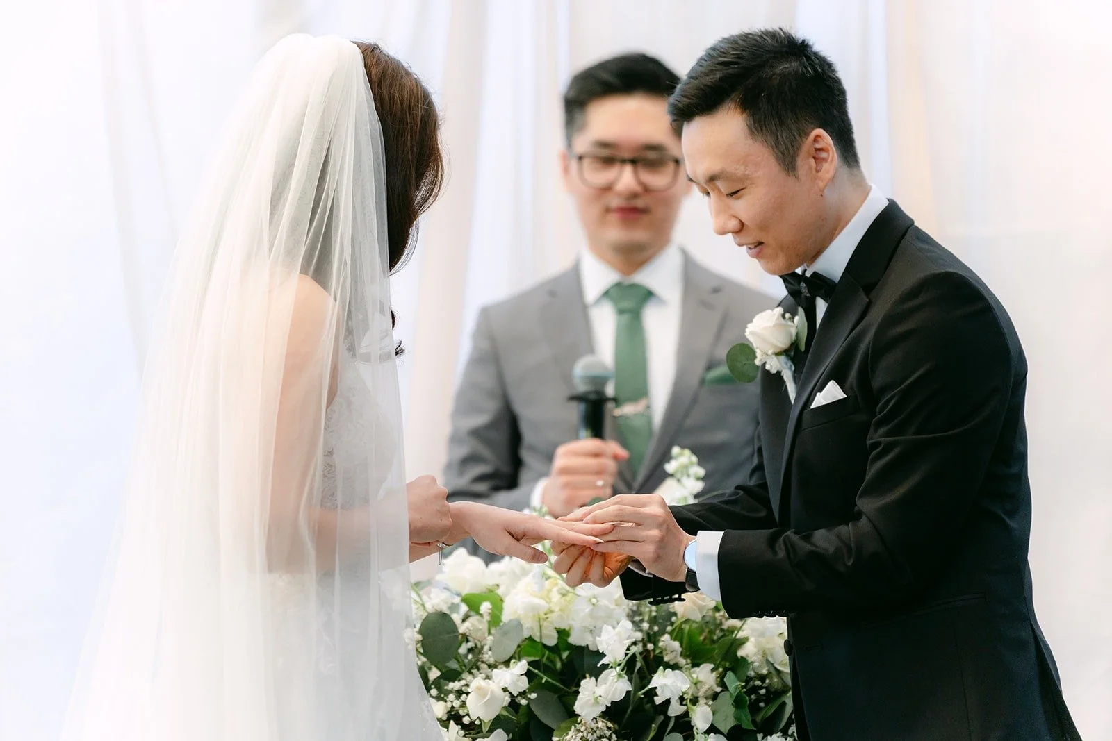 Jason placing a ring on Valerie's finger