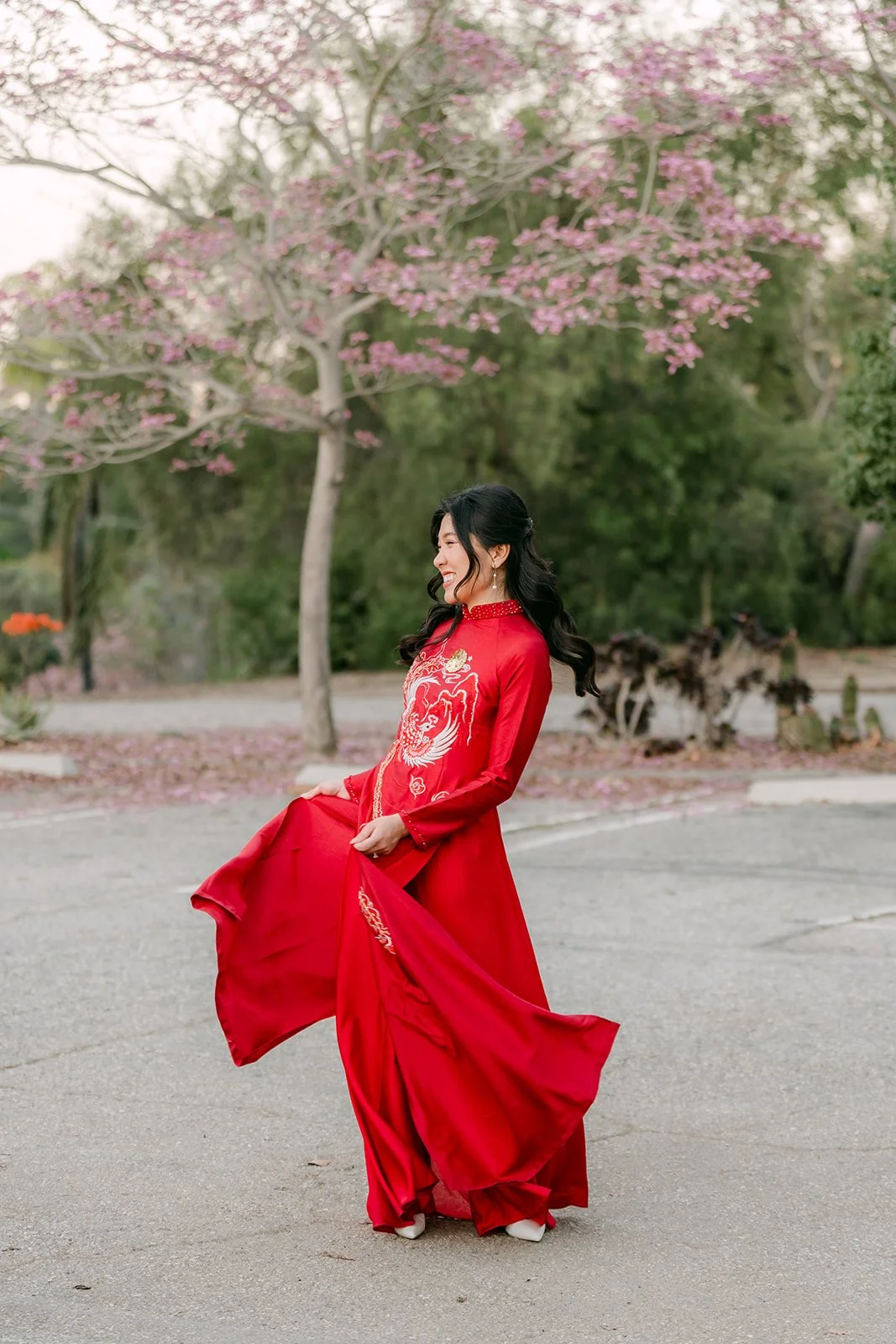 Kim swirling the long panels of her red ao dai.