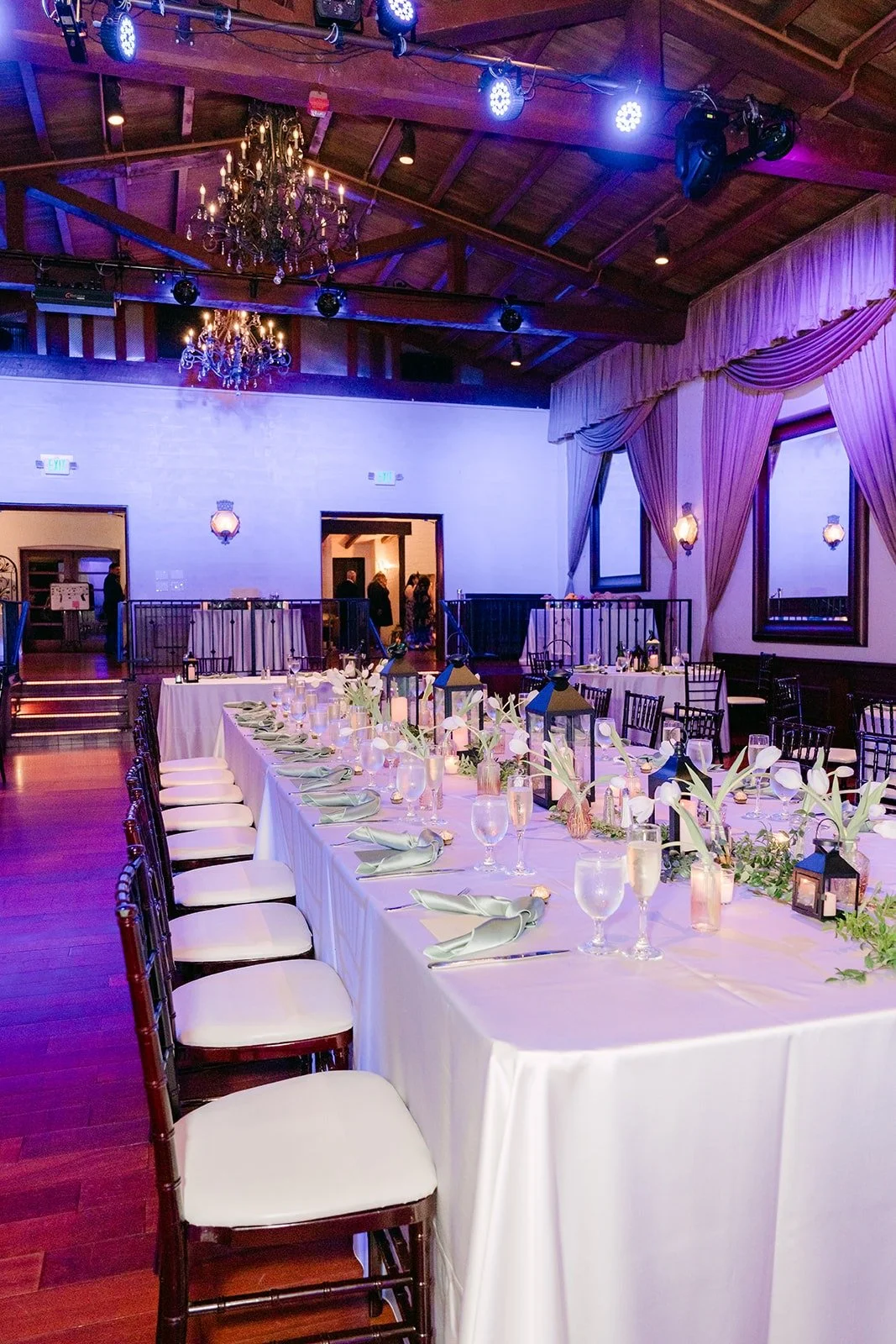 Long banquet tables under the beamed ceiling of the Padua Hills Theatre ballroom