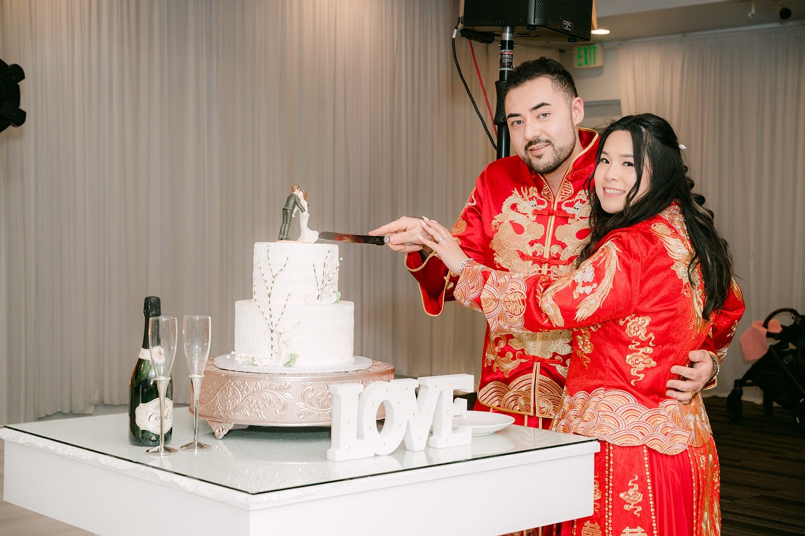 Amy and James cutting their white Portos cake