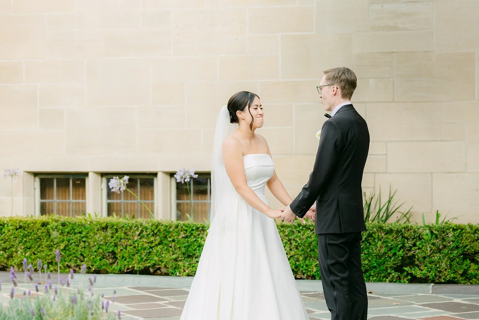 Wide view of the first dance with the hedges behind them