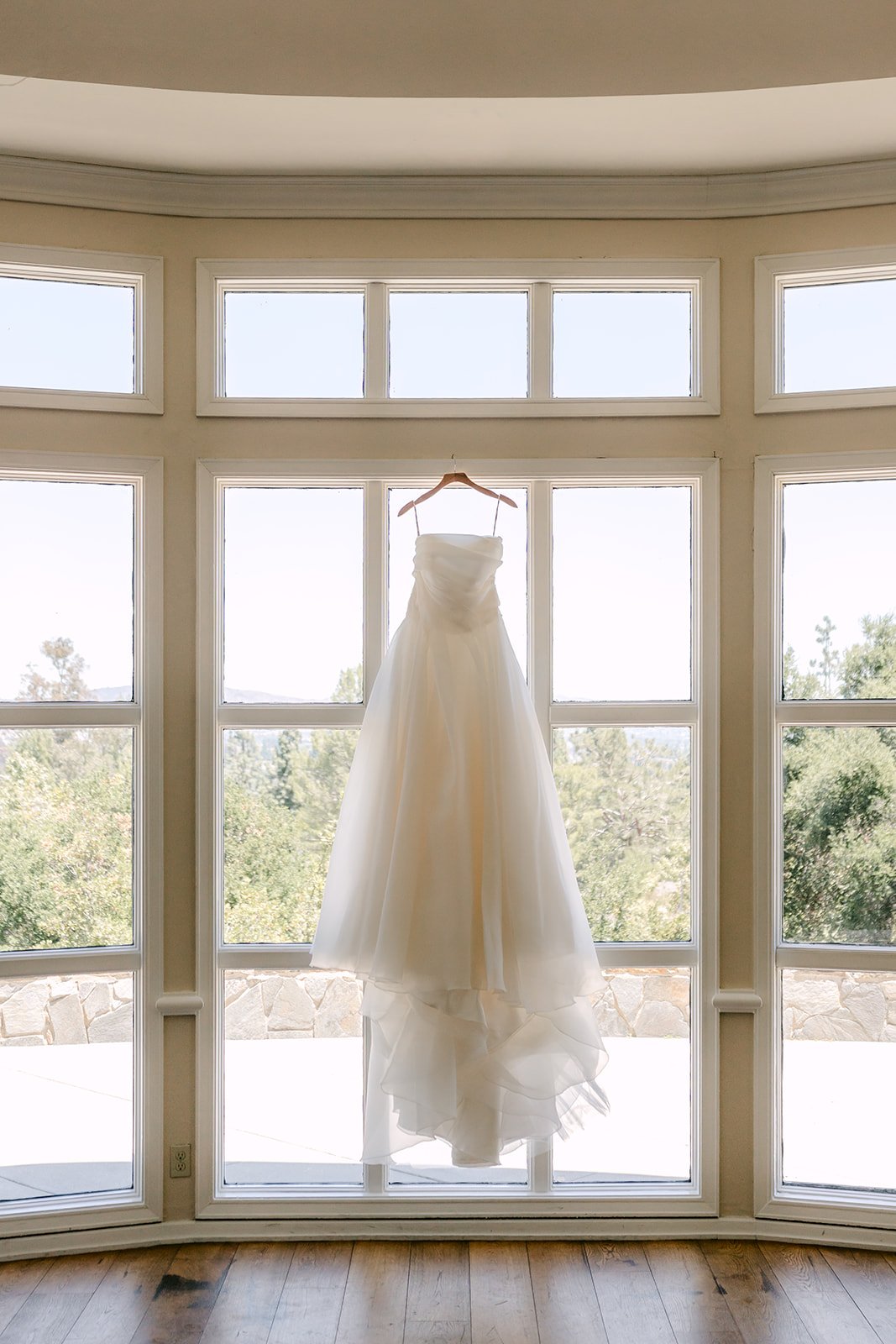 Judy's ball gown hanging in the bridal suite windows