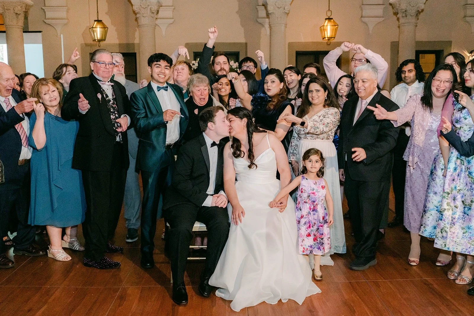 Guests cheering around Saira and Matthew, photographed by One and Only Production