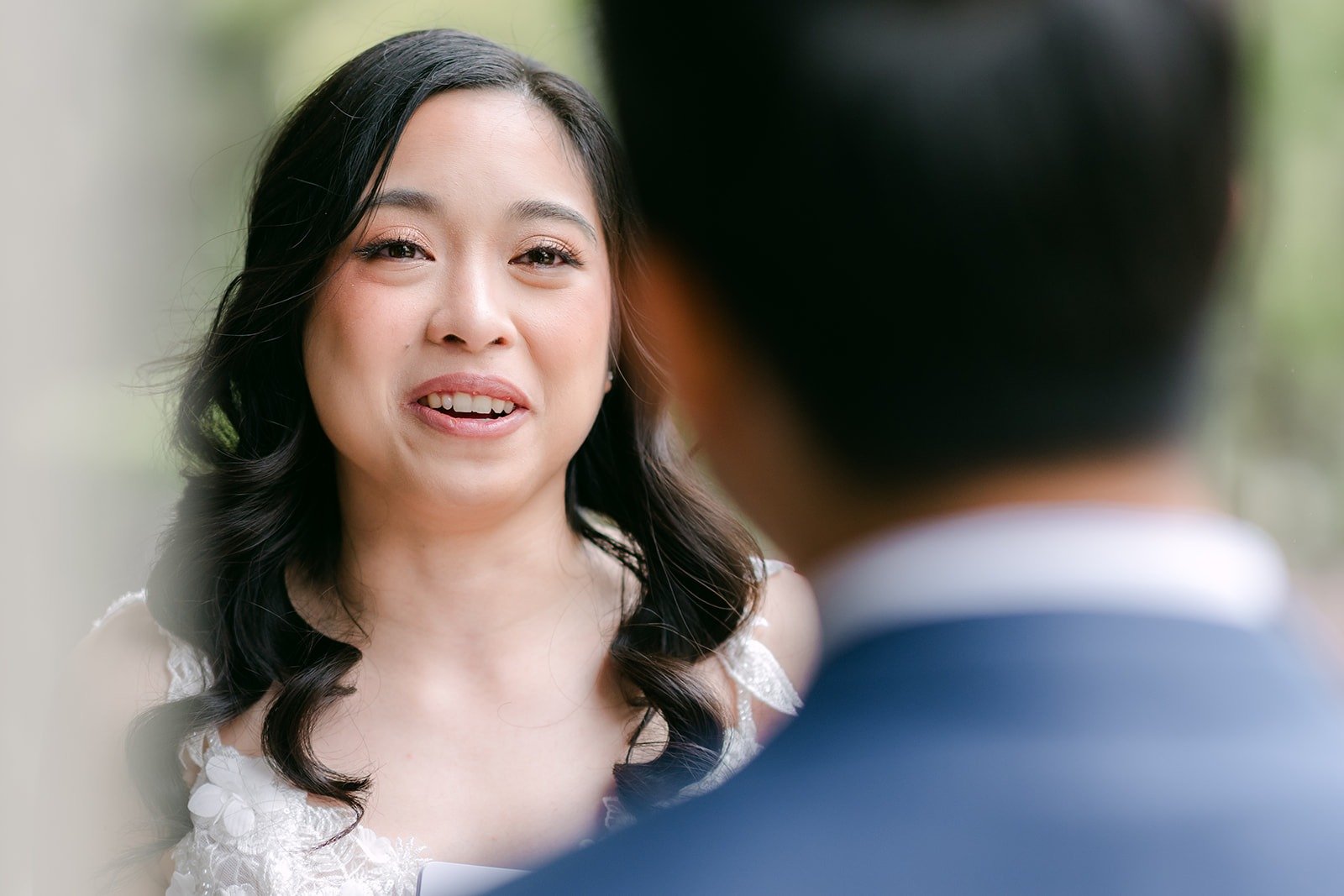 Natalie's emotional smile as Mark reads his vows to her