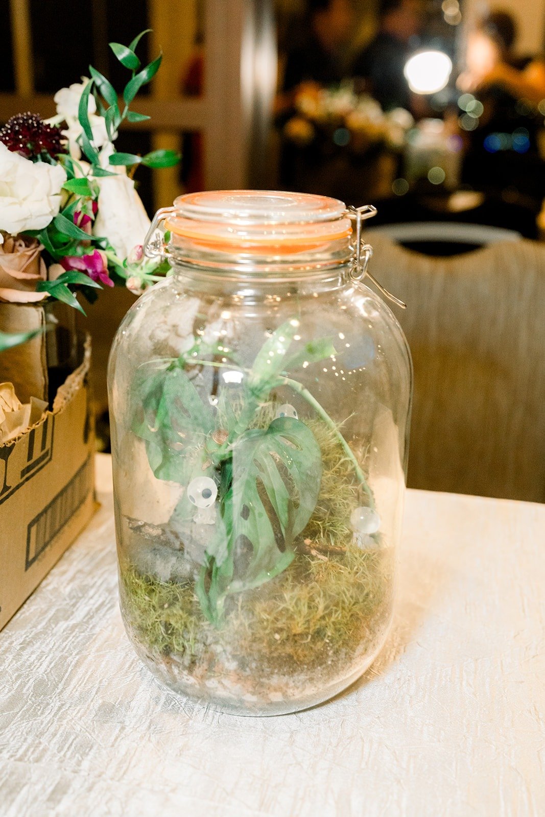 A glass jar terrarium on the reception table