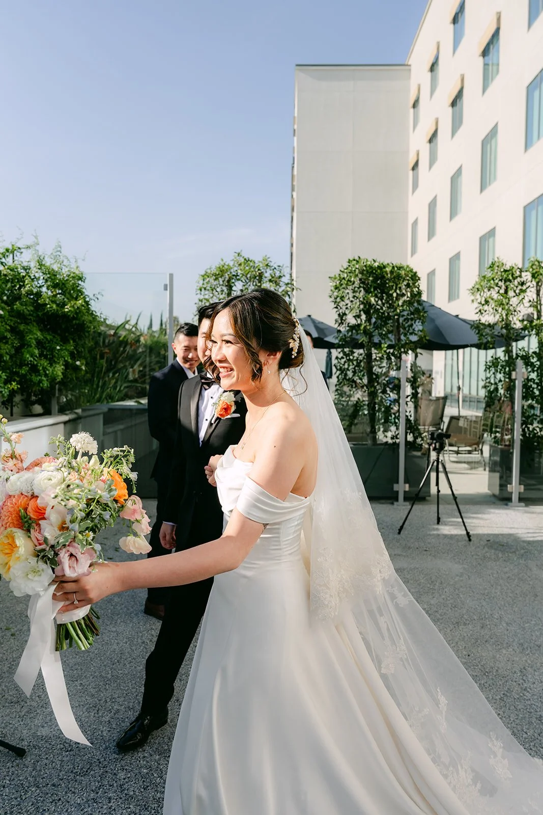 Amanda walking down the aisle on the terrace.
