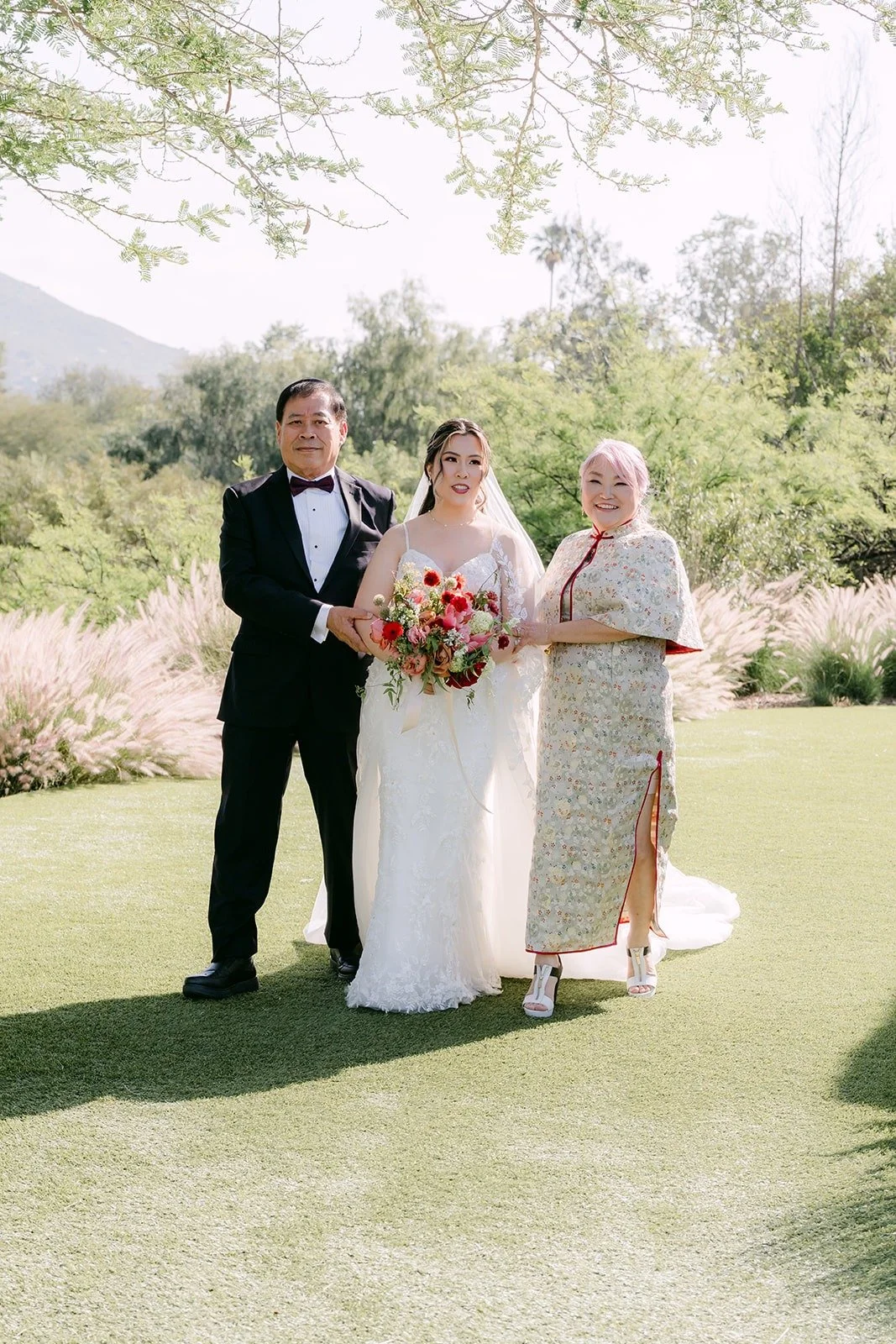 Joanne arriving at the aisle with two family members beside her